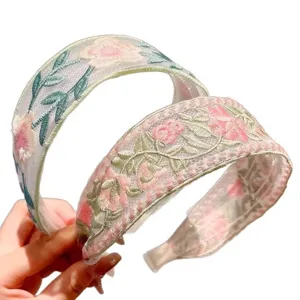 Elegant embroidered mesh headband with floral design, wide hair hoop for women and girls.