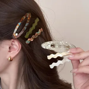 Acetate hair clip detail view, stylish wavy and oval hair accessories for daily style.