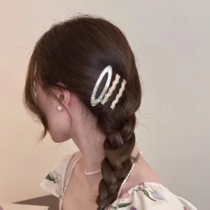 Elegant acetate hair clip set of three featuring unique wavy and oval designs for women styling.