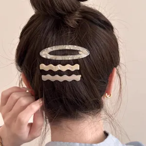 Detailed view of 3pcs acetate hair clips set, elegant wavy and oval barrettes for styling.