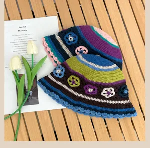 Handmade crochet bucket hat with colorful stripes and floral appliques, vintage retro knit cap.