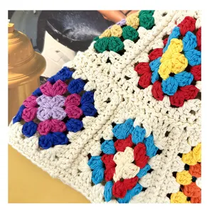 Handmade crochet floral pattern close-up detail, showing intricate hollow knit texture.