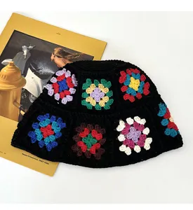 Handmade crochet bucket hat with colorful floral granny square patterns, cozy knit hat.
