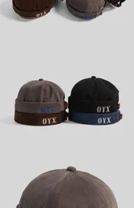 Détail de bonnet miki en velours côtelé avec lettres brodées et design streetwear.