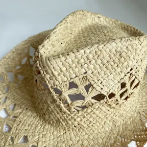 Close-up detail of woven raffia straw hat, summer beach sun protection jazz hat style.