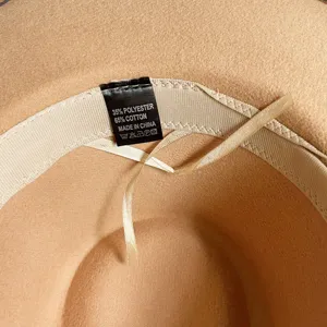 Close-up detail of fedora hat interior showing quality care label and inner lining design.