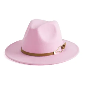 Close-up detail of the pink fedora hat, featuring a brown leather strap and gold buckle.