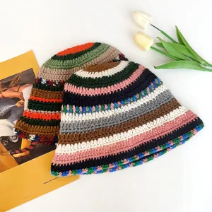 Handmade crochet bucket hat featuring vibrant multicolored stripes for a retro autumn winter look.