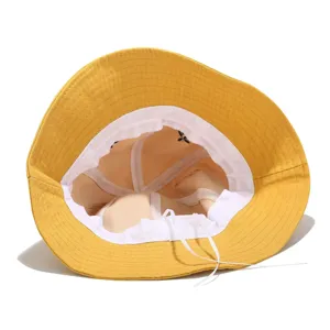 Yellow bucket hat interior detail showing adjustable drawstring and soft white inner lining designs.
