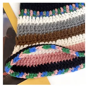 Close-up detail of a handmade colorful crochet bucket hat, showing fine knitted texture.