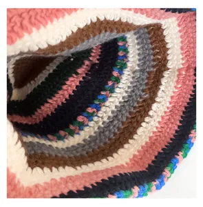 Close-up view of the handmade colorful striped crochet bucket hat texture, soft knit wool fabric.