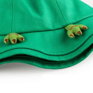 Close up view of the cute green bucket hat featuring 3D embroidered animal claw design details.