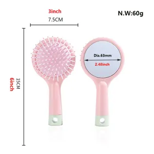 Detail view of pink plastic massage hairbrush with compact mirror, size and weight specs.