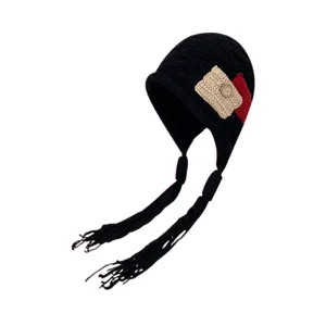 Knit earflap beanie hat with tassel braids and cute camera patch detail for winter warm