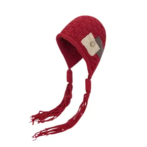 Cozy winter knitted beanie hat for women with cute long tassel braids, warm earflap style.