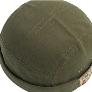 Vintage army green docker cap for men and women, classic retro sailor cap with patch detail.