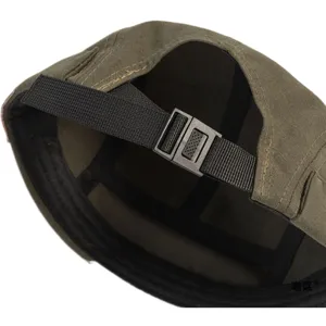 Close-up detail of the adjustable strap and buckle on an olive green miki dock cap.