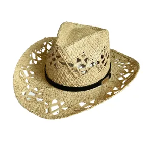 Close-up of the hollow-out straw hat weaving texture, black leather strap and metal buckle detail.