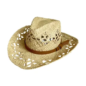 Close-up detail view of woven straw sun hat with cutout design and brown leather belt.