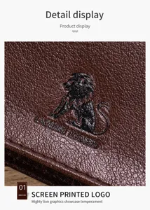 Close-up detail view of genuine leather wallet showing embossed lion logo and fine texture.