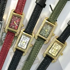 Detailed shot of women quartz watches, rectangular dials with rhinestone bezels and leather straps.