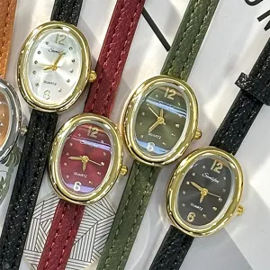 Vintage oval quartz watch for women with thin leather strap and classic metal case design.