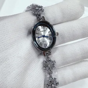 Detailed view of women's elegant oval quartz watch with crystal snowflake bracelet.