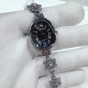 Detailed close-up view of the elegant oval quartz watch with delicate snowflake bracelet details.