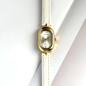 Detailed view of MICAI women quartz watch, oval gold-tone case with white leather strap.