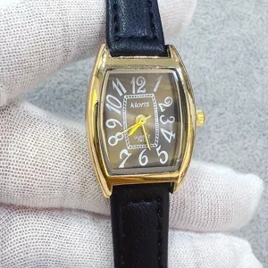 Women tonneau quartz watch with black leather strap and classic brown number dial.