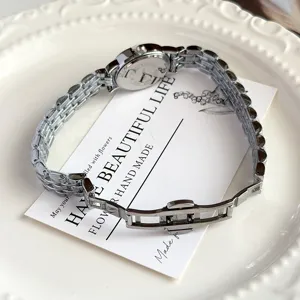 Women's silver stainless steel watch with small oval dial and butterfly clasp elegant accessory.