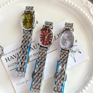 Detailed close-up of exquisite MICAI oval quartz ladies watches with metal bracelets.