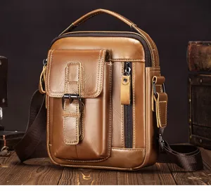 Close-up detail of genuine leather brown men crossbody bag with vintage style and metal zipper.