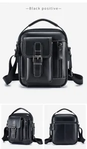 Detail view of men's black leather vertical messenger bag with front pocket and sturdy handle.
