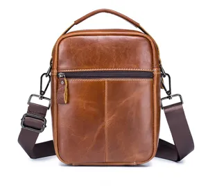 Men's vintage brown cowhide leather crossbody shoulder bag detail view with metal hardware.