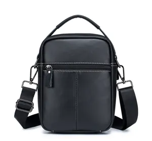 Close-up detail of the black leather vertical men's crossbody shoulder bag with hardware.
