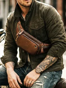 Vintage genuine leather chest bag for men, stylish brown cowhide waist bag with multiple zippers.