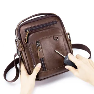 Leather scratch resistance detail closeup of men vintage brown crossbody messenger bag.