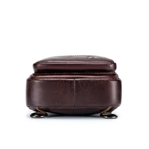 Men's genuine leather chest bag detail view, premium brown cowhide with metal rings.