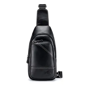 Detail view of black genuine leather chest bag showing fine texture and front zipper pocket.