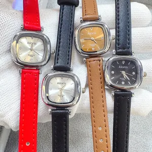 Detail view of women quartz watches with small square dials and slim leather straps in various colors.