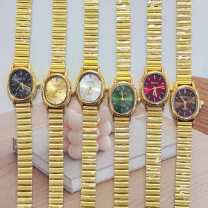Vintage gold small oval quartz watch for women with stylish chain strap, retro fashion accessory.