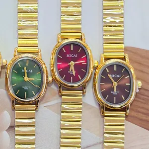 Detailed view of vintage oval quartz watch with metallic stretch band and colorful dial.