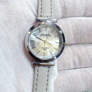 Kloris women quartz watch detail shot, grey leather strap and simple round dial.