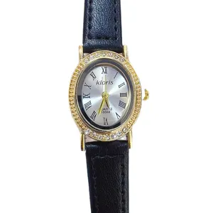 Women's oval quartz watch with rhinestone bezel, silver dial and black leather strap