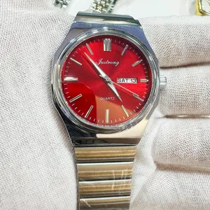 Men's quartz watch with striking red dial, stainless steel integrated strap and day date display.