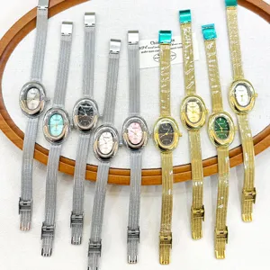 KOUSHI women quartz watch with elegant oval bezel and sleek stainless steel mesh strap.