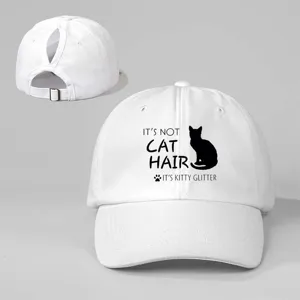 White ponytail baseball cap detail showing the back adjustable strap and cat graphic front.
