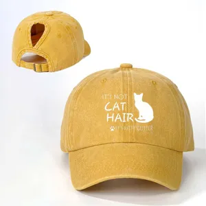 Distressed washed yellow ponytail baseball cap with funny cat quote print for outdoor wear.