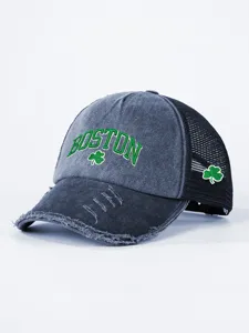 Distressed grey black trucker hat detailed view featuring green Boston embroidery clover accents.